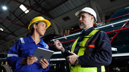 Group of apprentices with instructor at railway engineering facility. Teacher talking to apprentices at railway engineering facility