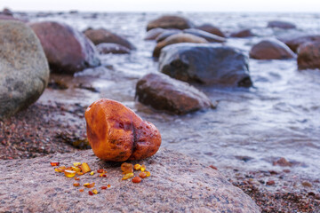 Huge bright yellow amber with sand, sea and rocks