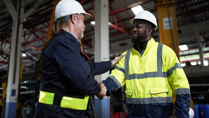 Portrait of engineer and apprentice in workshop of railway engineering facility