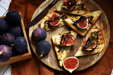 Fig toast with cheese, olive oil, spices and balsamic vinegar. Bruschetta with figs.