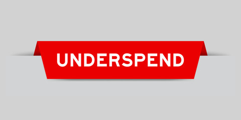 Red color inserted label with word underspend on gray background