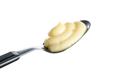 Spoon with tasty vanilla pudding on white background, closeup