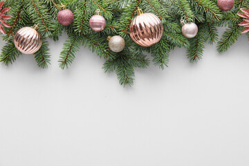 Fir tree branches and Christmas balls on white background