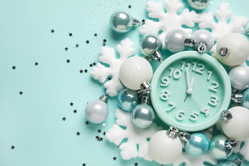 Vintage alarm clock with Christmas decor on blue background