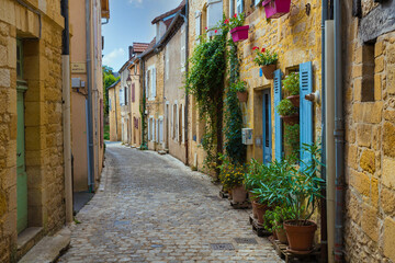 a small old street in a French village with limestone houses
