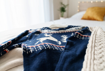 Two Knitted sweaters on the bed