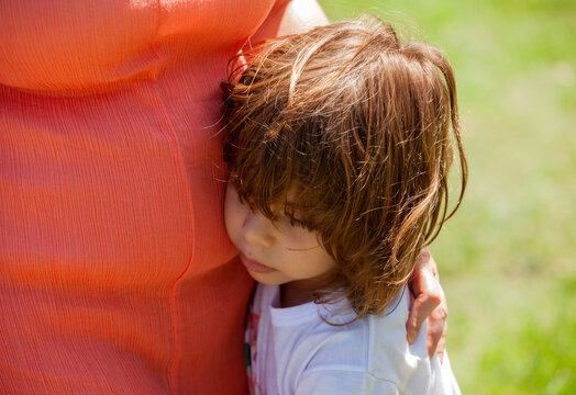 Little Girl Hugging Mather In The Park