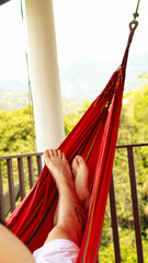 relaxing outdoors in a hammock
person on a hammock on a balcony
