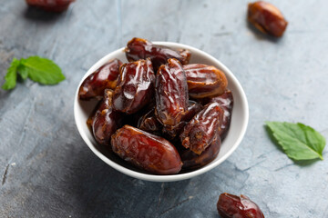 Organic dried Dates fruit in white bowl