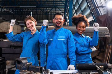 Engineer senior asian man and african woman wearing safety helmet working and checking machine  automotive part warehouse. Factory for the manufacture and processing.