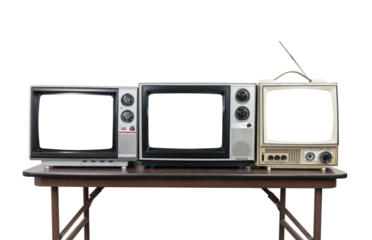 Three vintage televisions on wood table isolated with cut out screens.