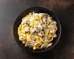 Creamy Alfredo pasta with chicken, mushrooms and parmesan cheese. Healthy Italian food