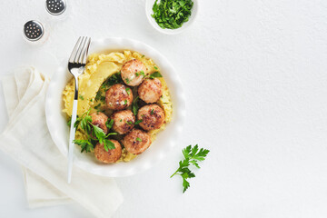 Swedish meatballs in cream sauce, potatoes and lingonberry sauce in bowl on slate, stone or concrete backgrounds. Swedish cuisine. Delicious creamy mashed potatoes. Top view.