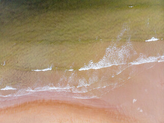 Fototapeta premium Surf line on the sandy beach of the Barents Sea. Teriberka