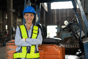 African American female driver forklift truck in heavy metal industrial factory. Smiling woman...