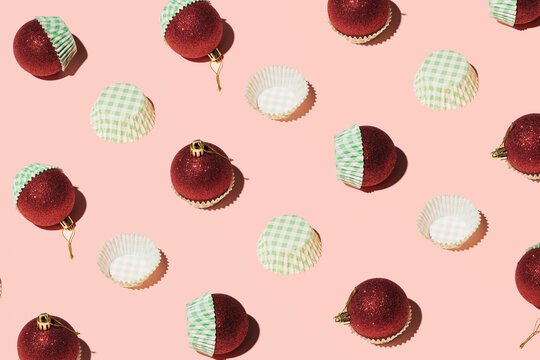 Red Christmas Baubles In Green Square Pattern Cupcake Liners, Creative Winter Holidays Layout, Candy Pink Background. 