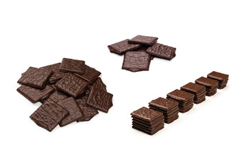 Dark chocolate candies isolated on white background.