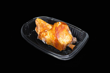 Roasted half chicken in a black package