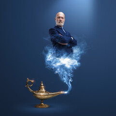 Fototapeta na wymiar Business executive coming out from a magic lamp