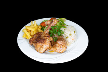 Grilled chicken chops with rice, salad and french fries in a white plate