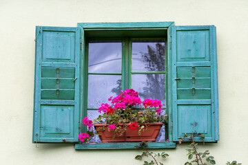 Fototapeta na wymiar A rustic window decorated with flowers