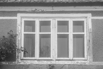 A rustic window in black and white