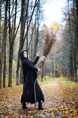 A woman in a witch suit in a forest