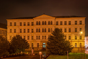 Fototapeta na wymiar Gymnasium school building in dark autumn evening in Decin town