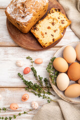 Homemade easter pie with raisins and eggs on plate on a white wooden background. top view, close up.