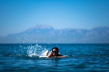 girl playing with water at the sea 