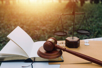 Business and lawyers discussing contract papers with brass scale on desk in office. Law, legal services, advice, justice and law concept picture with film grain effect