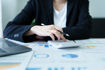 Accountants, Asian auditors are using calculators and computers to review annual tax budgets to submit information to the IRS.