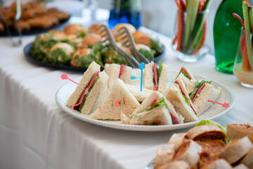 Banquet table with snacks, food on plates, festive table, corporate food