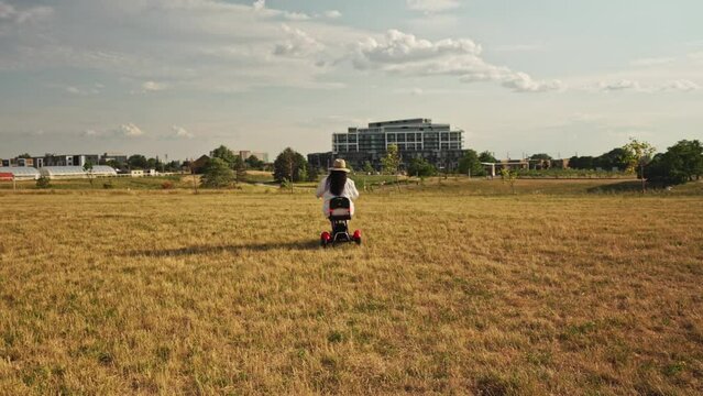 Woman with a disability in an electric scooter wheelchair driving around summer park in the evening. Mobility electric vehicle for independence and accessibility.