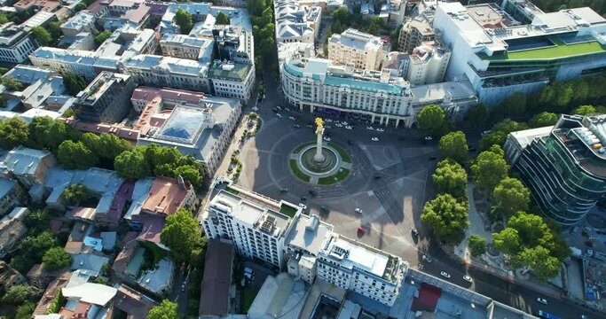 Aerial view of Freedom Square in Tbilisi, Georgia. Traffic of cars at the roundabout intersection. View from the height of the city. High quality 4k footage