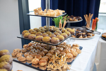 Banquet table with snacks, food on plates, festive table, corporate food