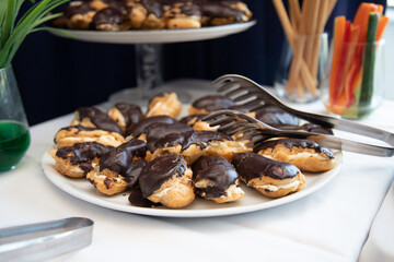 Banquet table with snacks, food on plates, festive table, corporate food