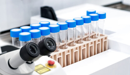 Microscope with Many test tubes in the laboratory. Concept collection of blood in cases for...
