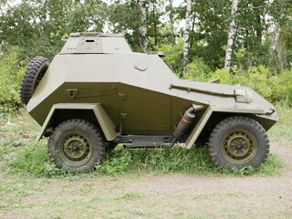 Fototapeta premium A small four-wheeled armored car with a swivel turret without a machine gun. The use of camouflage on military cross-country vehicles of the Second World War.