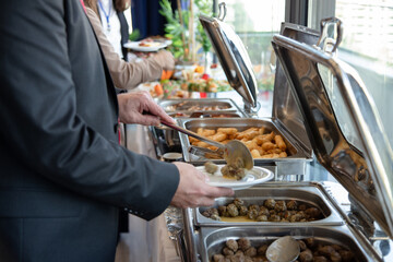 Banquet table with snacks, food on plates, festive table, corporate food