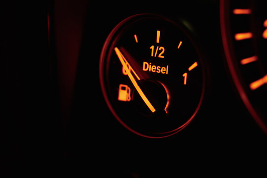 Empty fuel tank backlighting on car dashboard in the darkness