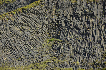Basalt columns on Reynisfjara black volcanic sand beach in iceland by the ocean