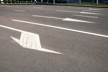 Arrow road markings on the asphalt closeup