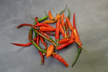 bunch of fresh chilies on a concrete background