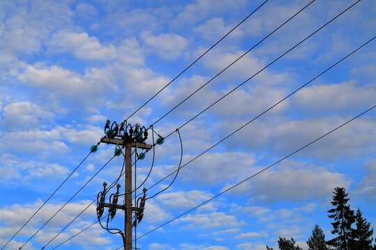 20kV current power lines. Wooden pole. Sky in the background. Stockholm, Sweden.