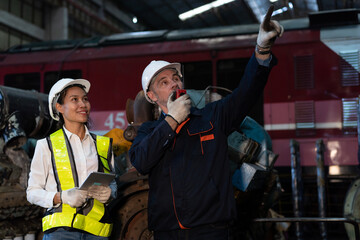 Group of engineer workers working and checking or maintaining machinery, mechanical machine at the...