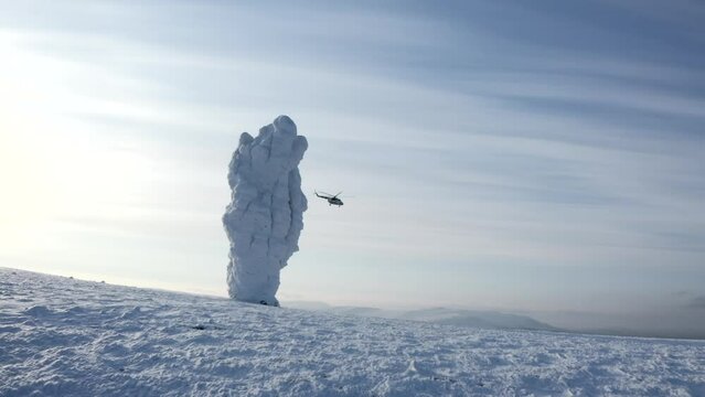 Aerial winter view of giants of the Manpupuner Plateau, Komi Republic. Clip. Helicopter flying above snow covered hills.