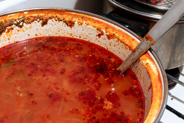 A full pot of red Ukrainian borscht. Ukrainian borscht in a large pot
