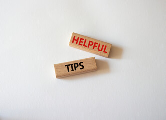Helpful tips symbol. Wooden blocks with words Helpful tips. Beautiful white background. Business and Helpful tips concept. Copy space.