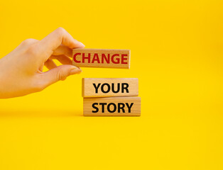 Change your story symbol. Concept word Change your story on wooden blocks. Beautiful yellow background. Businessman hand. Business and Change your story concept. Copy space